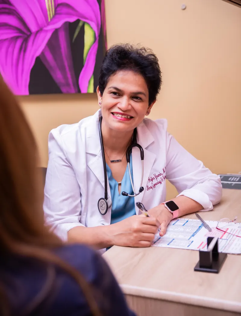 Dr. Yasmin listening to a patient during an in-depth consultation